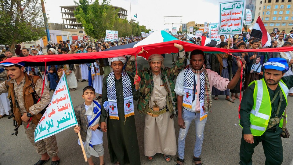 Demonstrators carrying flags and banners.