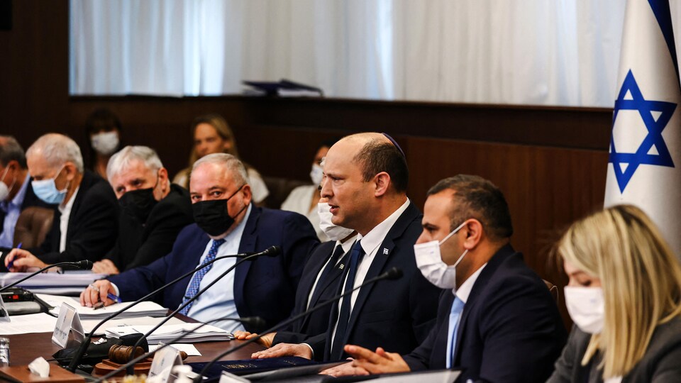 Israeli Prime Minister Naftali Bennet spoke, surrounded by members of his cabinet.
