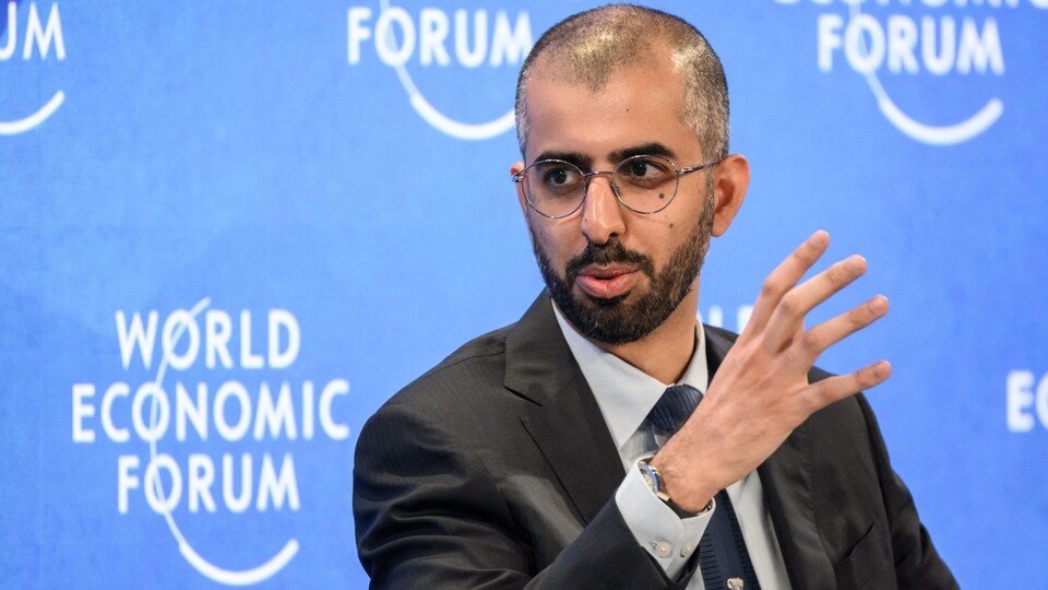 A young man wearing glasses and sporting a short beard during a panel discussion at the World Economic Forum.