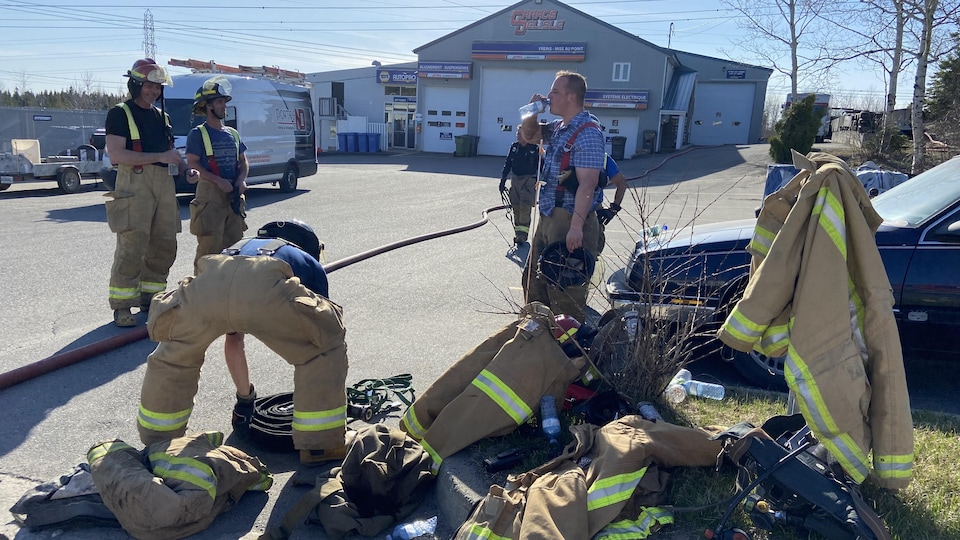 Firefighters gather after extinguishing the blaze.