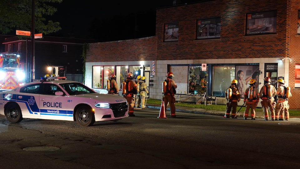 Des pompiers se trouvent à l'extérieur d'un commerce où un incendie criminel est survenu.