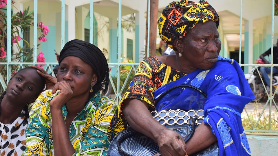 People sitting in front of the hospital