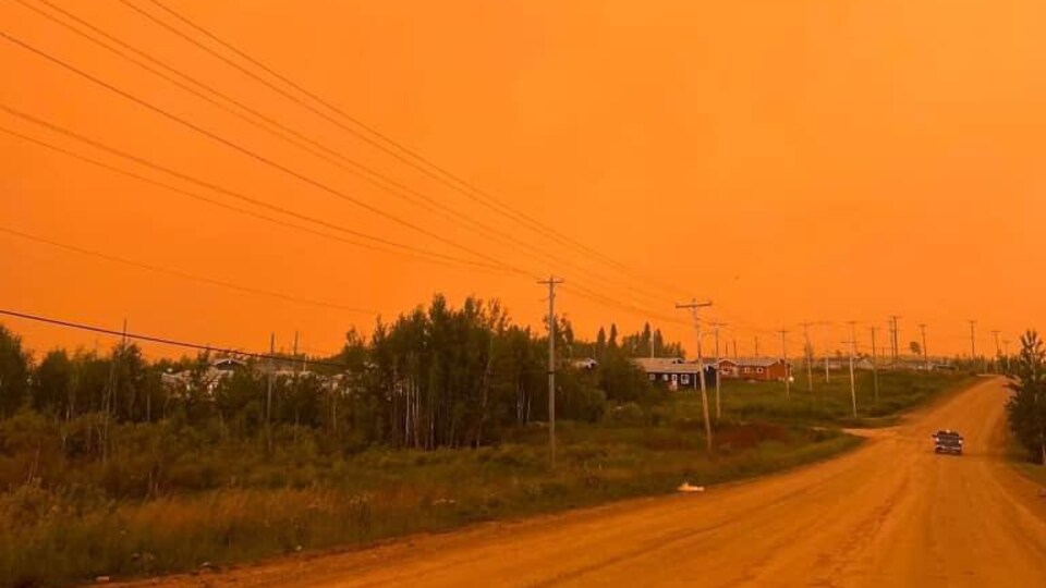 An orange sky due to smoke from a wildfire near the Mathias Columbus Cree Nation in Manitoba on July 14, 2022.