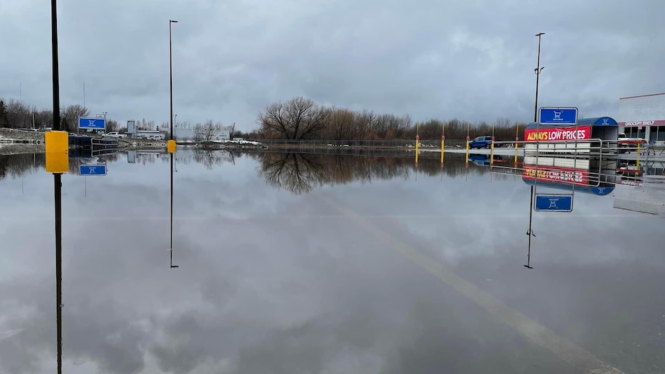 A layer of water spilled on the Walmart parking lot. 