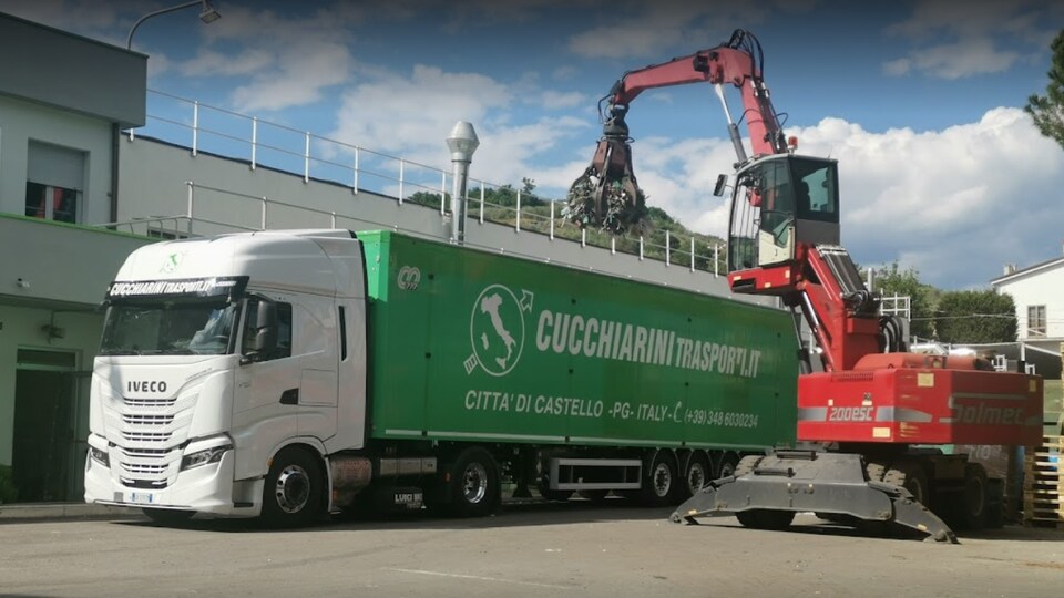 Une grue charge des déchets métalliques dans un camion en Italie.