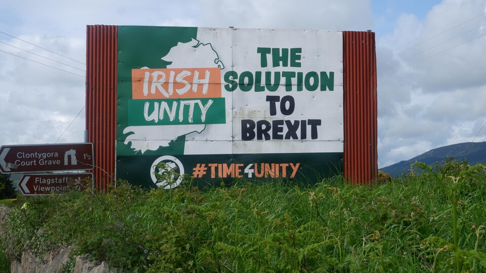 A poster shows up with a slogan on the side of the road.