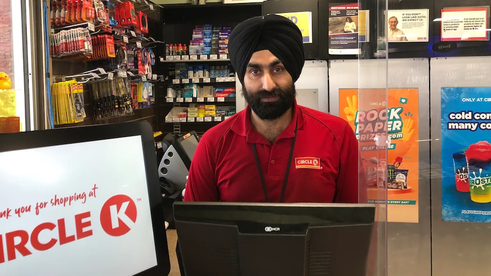Jaspreet Singh behind the cash register at the gas station.