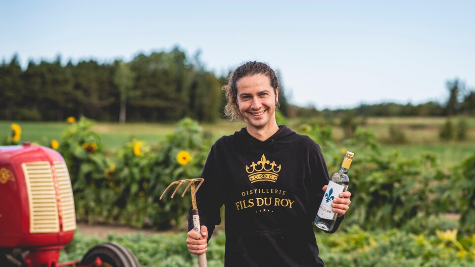 Jonathan Roy was holding a bottle of spirits in one hand and a rake in the other.