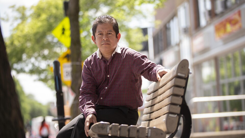 Joni Ismael Velazquez assis sur un banc public.
