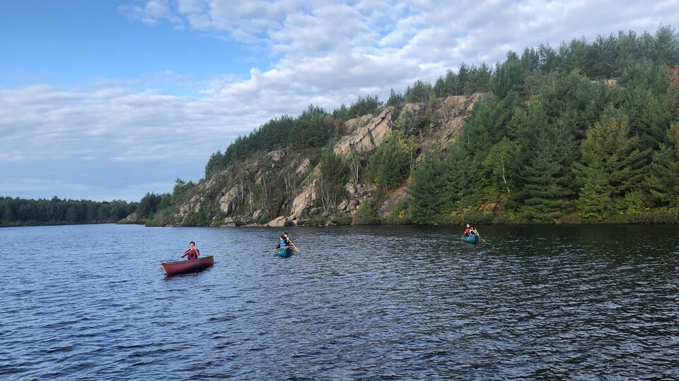 Justin Trudeau pagaye dans un canot, sur le lac Laurentien avec des jeunes de la région. 