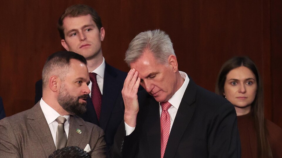 Kevin McCarthy, visibly disappointed, was surrounded by other Republicans.