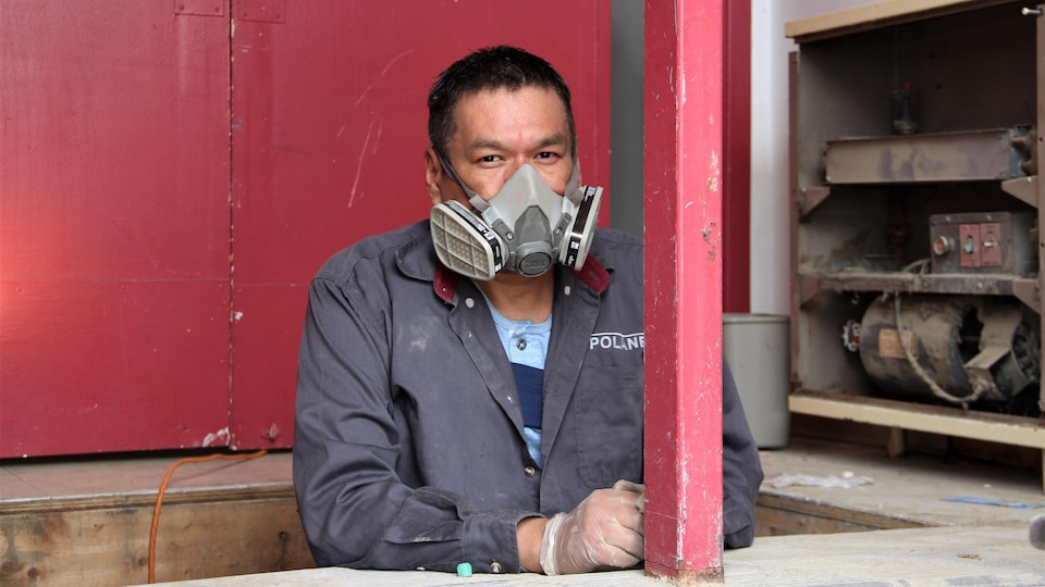 A man in a hole with a mask on his face.