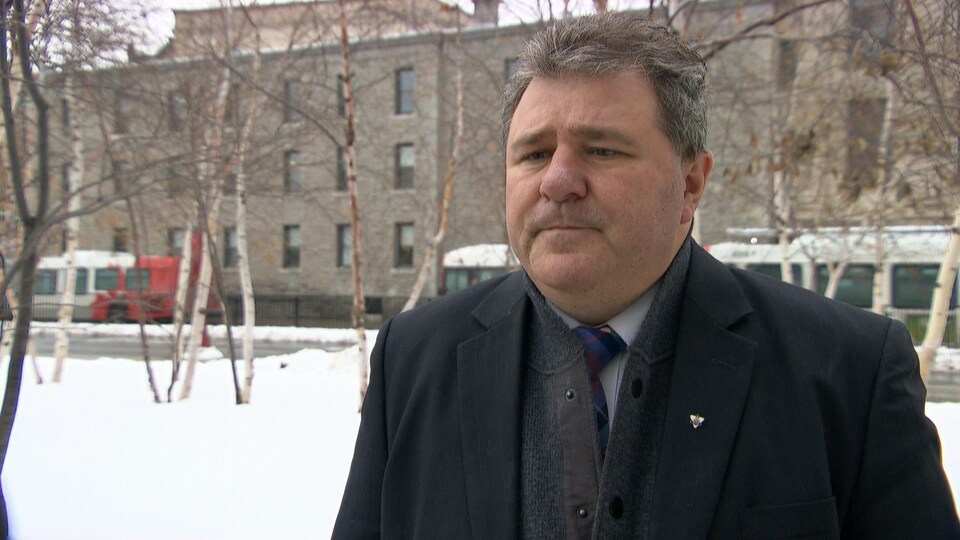 Gilles Levasseur answers a journalist's questions on the University of Ottawa campus.