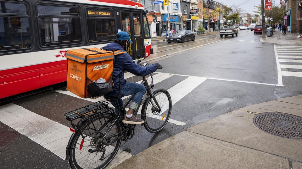  Un livreur d'Uber Eats à vélo dans une rue de Toronto.