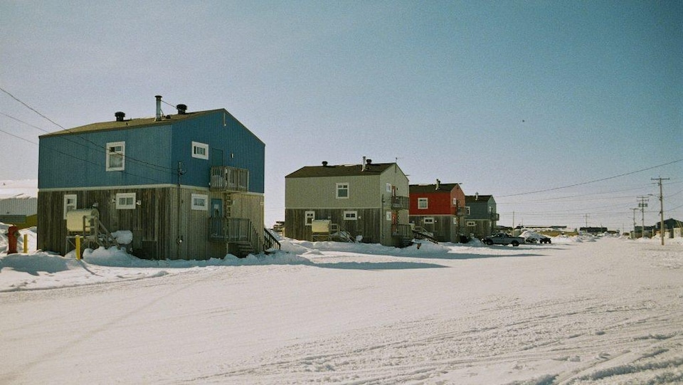 Two-storey houses on a snowy street.