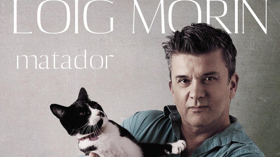 un homme qui tient un chat noir et blanc.