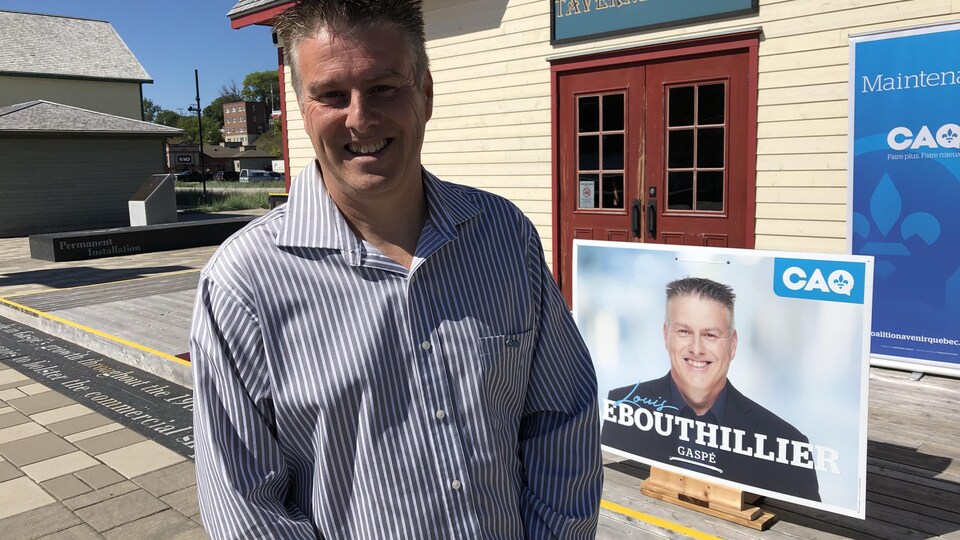 Louis LeBouthillier, dehors devant une pancarte électorale à son nom
