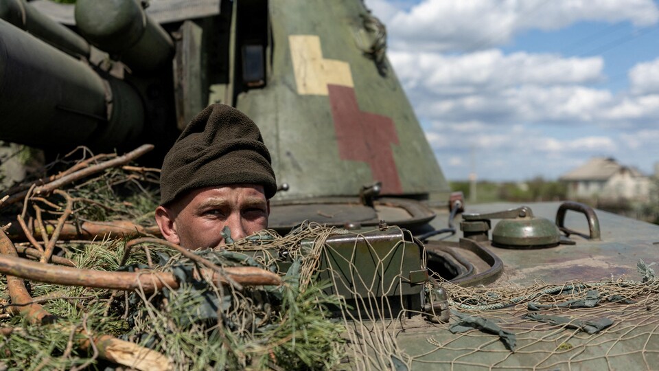 Un soldat ukrainien sort sa tête d'un tank. 
