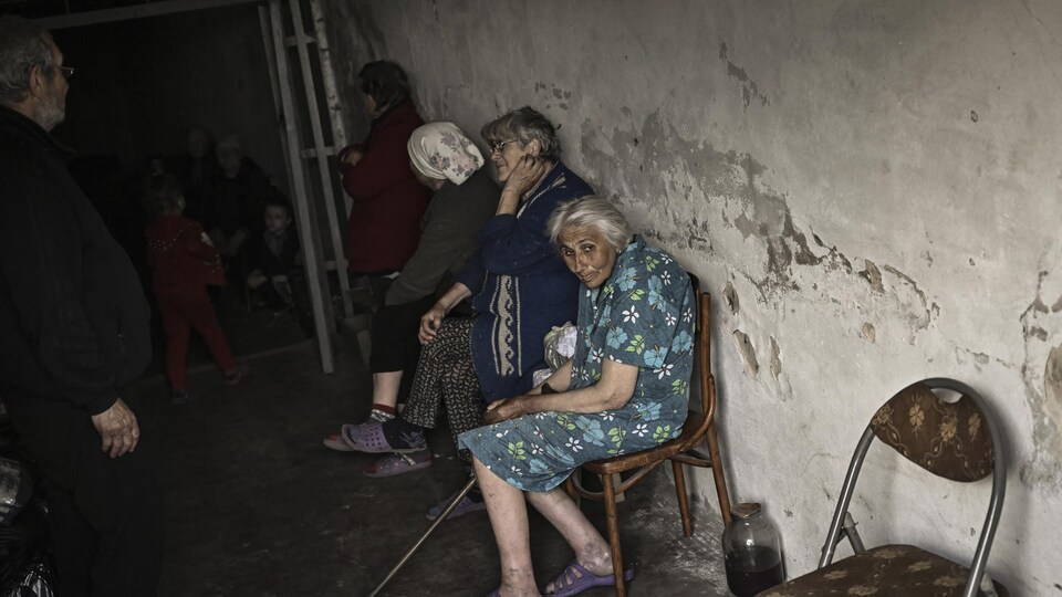 The elders were sitting on chairs in a dark basement.