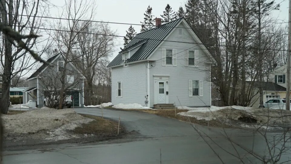 A white house with a black roof.