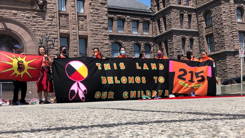 Protesters hold a banner