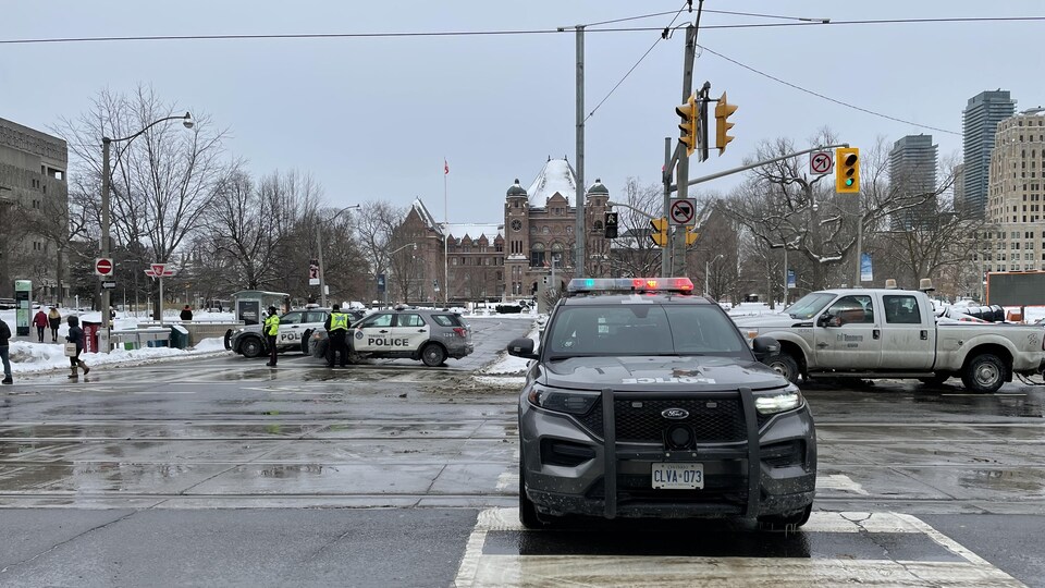 Des véhicules de police barrent l'accès à l'avenue University, qui mène à Queen's Park, lieu de rassemblement prévu des camionneurs ce week-end.
