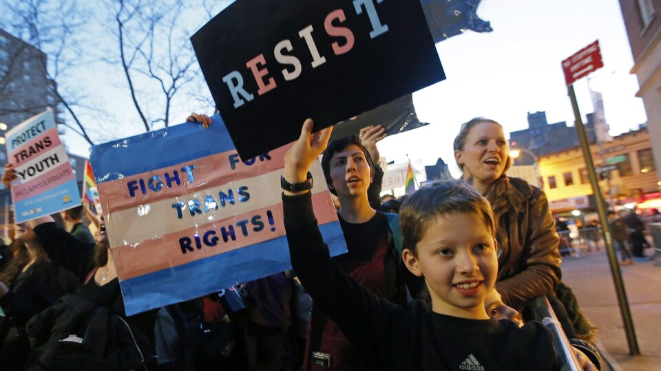 Un enfant qui tient une pancarte dans une manifestation
