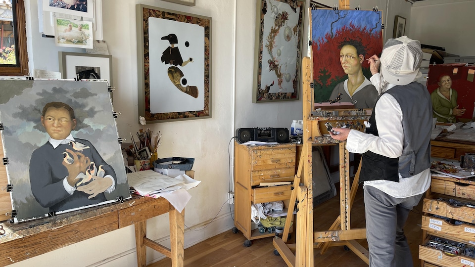 Julie Speed ​​in front of a painting in a studio.