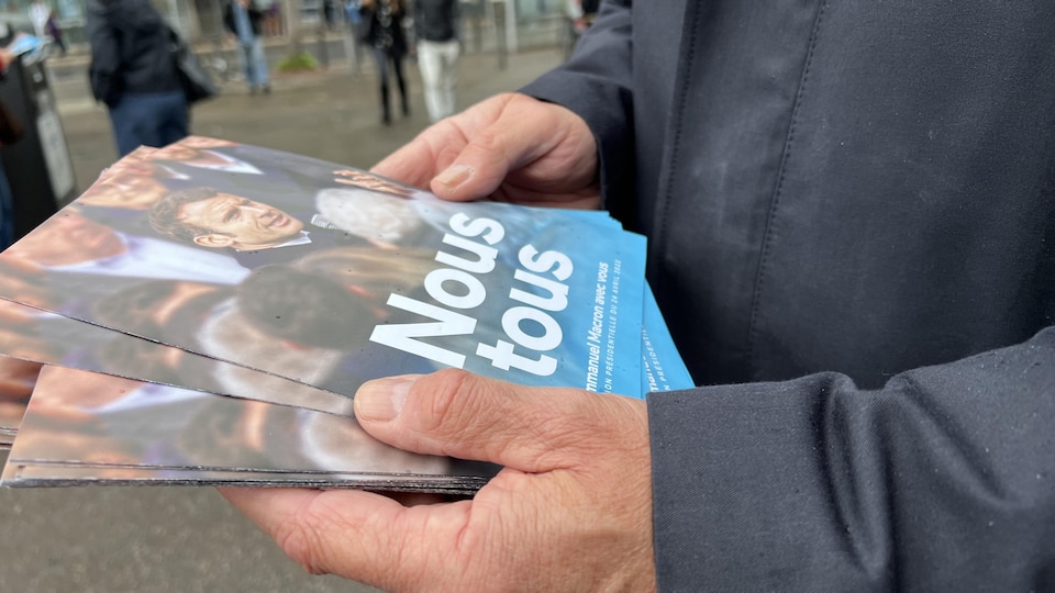 Activists distribute Macron campaign flyers near a metro entrance in Marseille. 