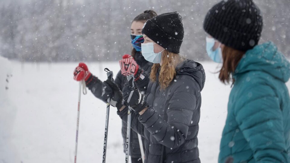 Trois amies font du ski de fond sous la neige le 16 janvier 2021 à Westboro, en Ontario.