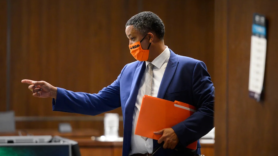 Matthew Green wearing an NDP mask and pointing at a man.