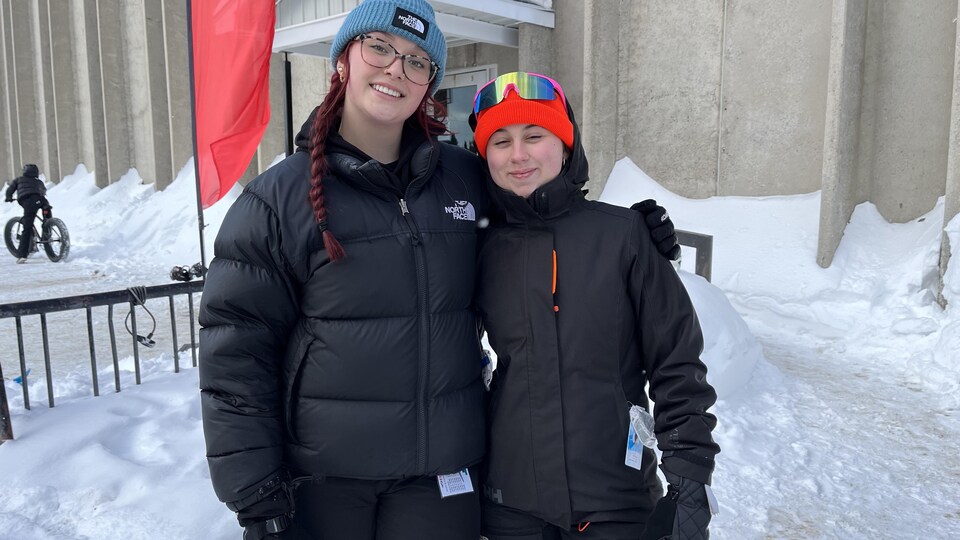 Deux participantes se font une accolade à l'extérieur. 