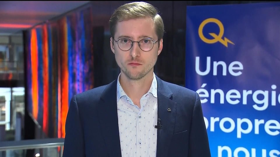 A Hydro-Québec representative looks directly into the camera lens during a TV interview.