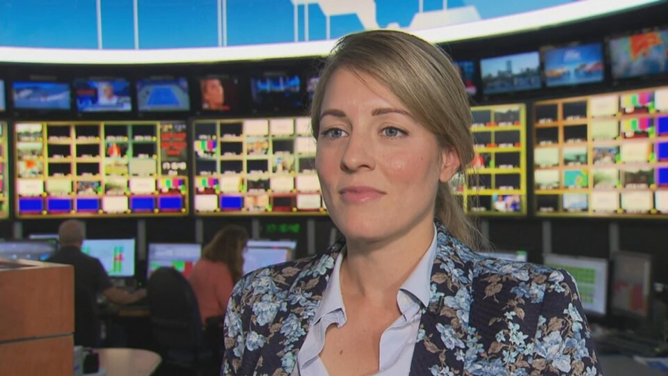 Mélanie Joly devant les écrans du centre de l'information de Radio-Canada.
