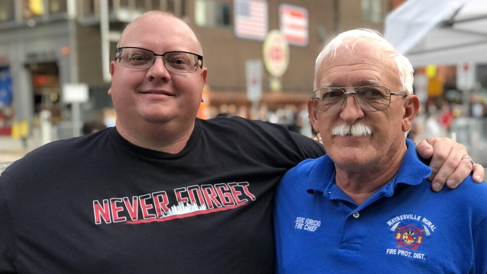 Michael Nicola has his left arm around Doug Yurekco's shoulders.