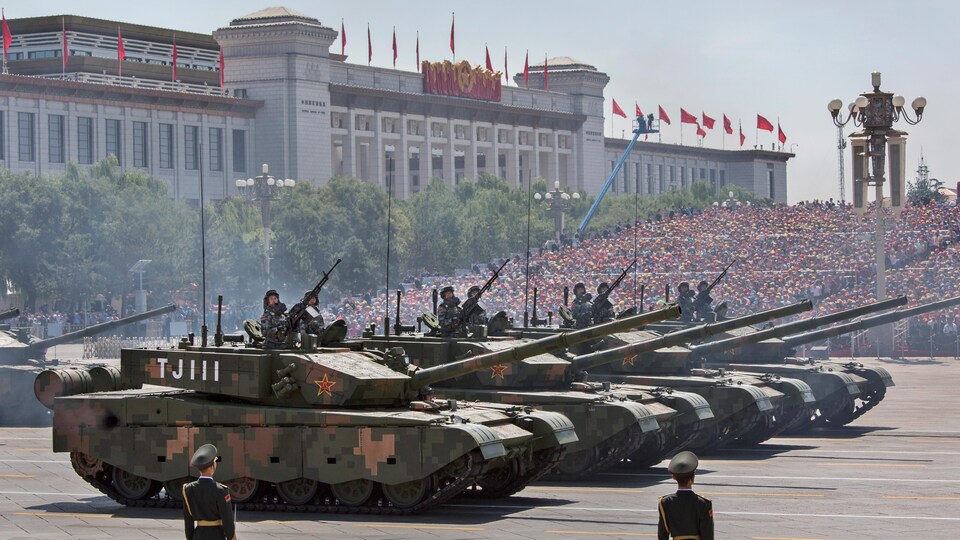 Parade militaire chinoise : des chars d'assaut défilent devant une foule.