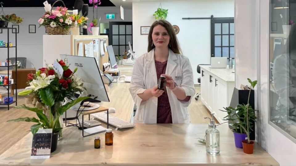 Miranda Teasdale, pharmacienne, tient un flacon en verre dans ses mains.