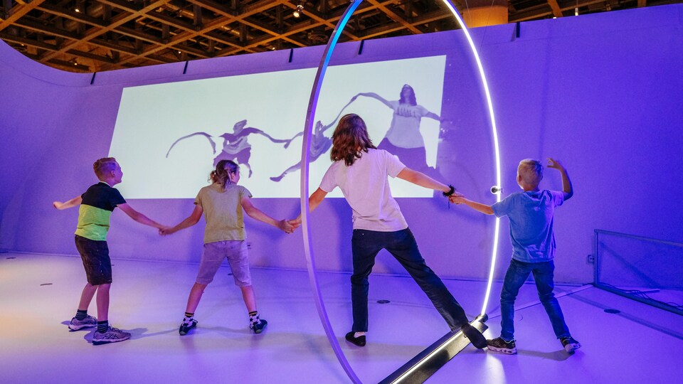 Des enfants jouent avec un anneau lumineux. 