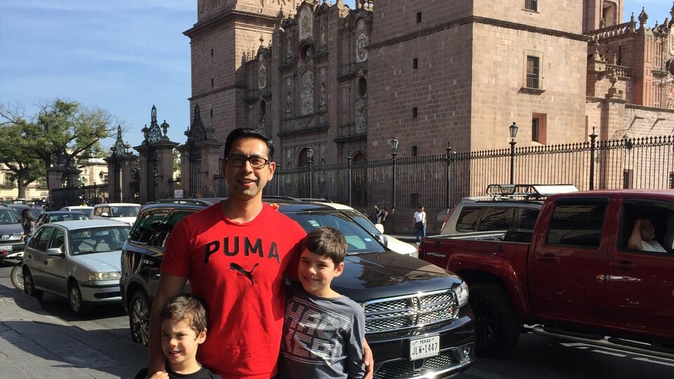 Le Mexicain Alberto Velasco posent devant devant la cathédrale de Morelia au Mexique. Il est accompagné de ses deux garçons.