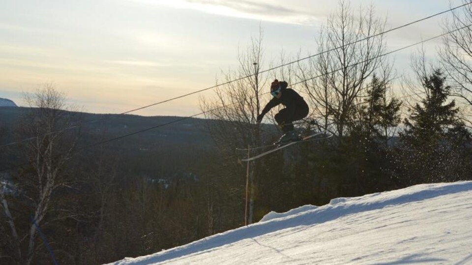 Un skieur lors d'un saut sur une montagne.