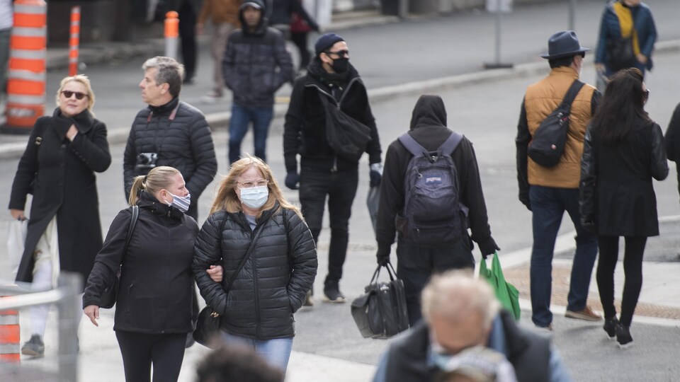 Des piétons portant des masques.
