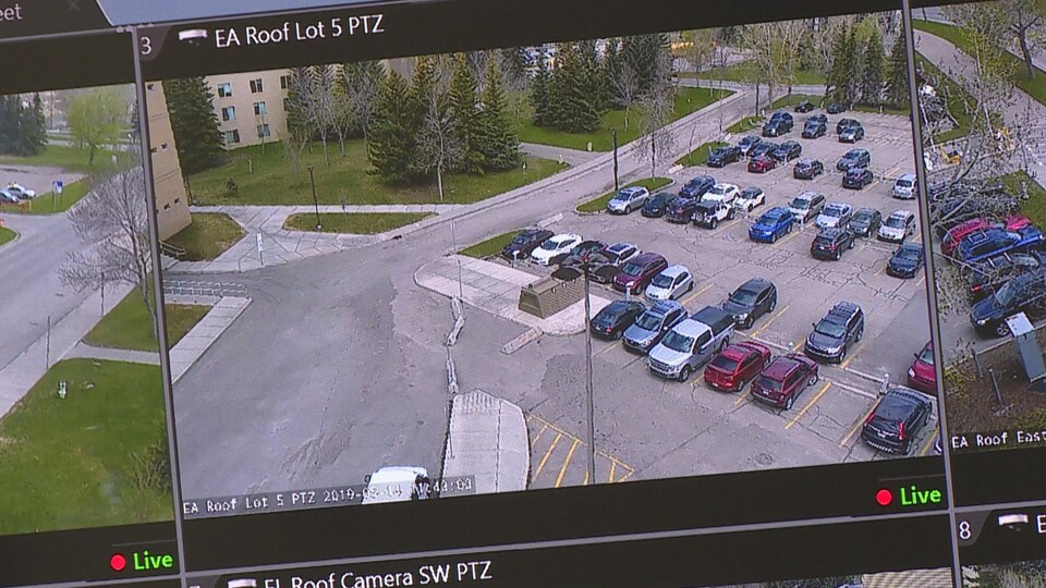 Un écran de surveillance avec des voitures stationnées. 