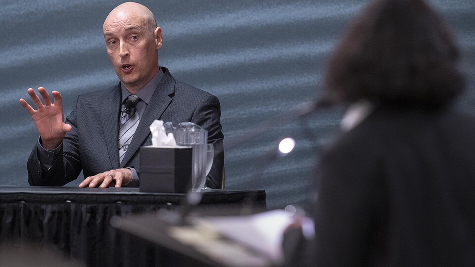 Nasha Nijhawan turns her back on the camera as Dave MacNeil answers a question.