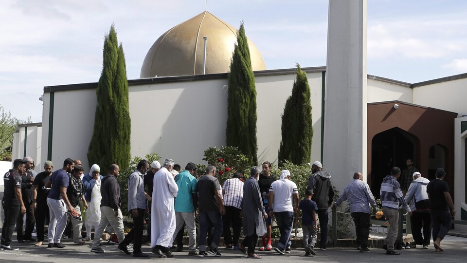 Worshipers line up to enter the Al-Noor Mosque in Christchurch.