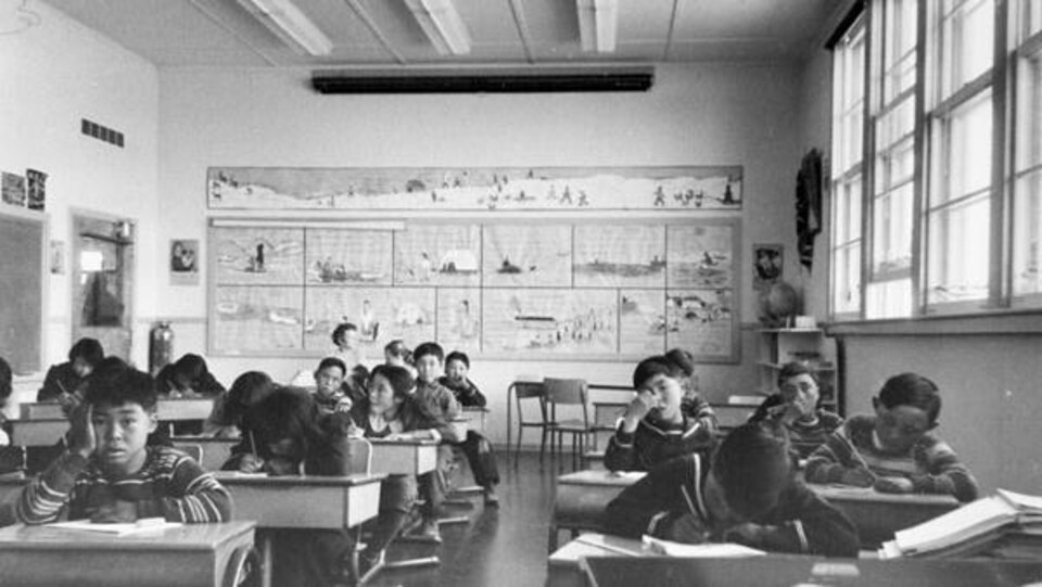 Des élèves de l'externat fédéral Sir Joseph Bernier de Chesterfield Inlet sont assis derrière leur pupitre, le 5 septembre 1958.