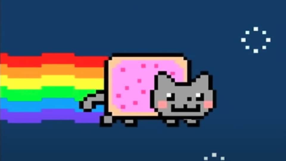 Un chat volant pixélisé laisse une trace arc-en-ciel derrière lui dans un ciel étoilé. 