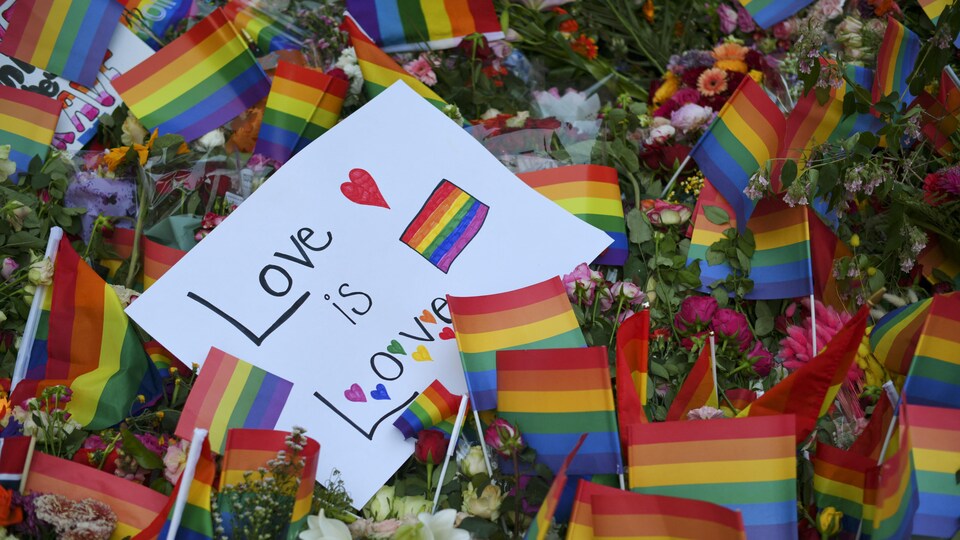 Des fleurs et des drapeaux arc-en-ciel déposés après une fusillade près d'un bar LGBT à Oslo.