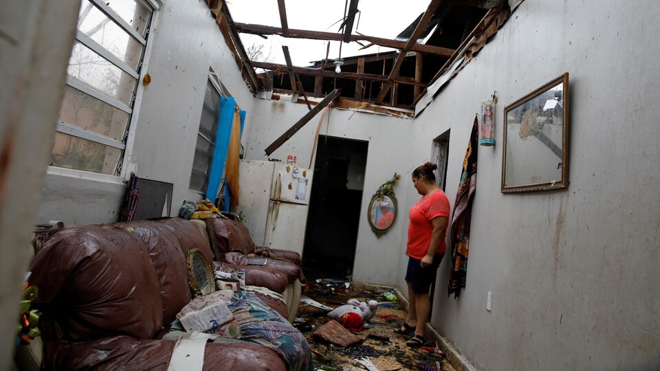 Une femme constate les dégâts après le passage de l'ouragan Maria dans la municipalité de Salinas sur l'île de Porto Rico.