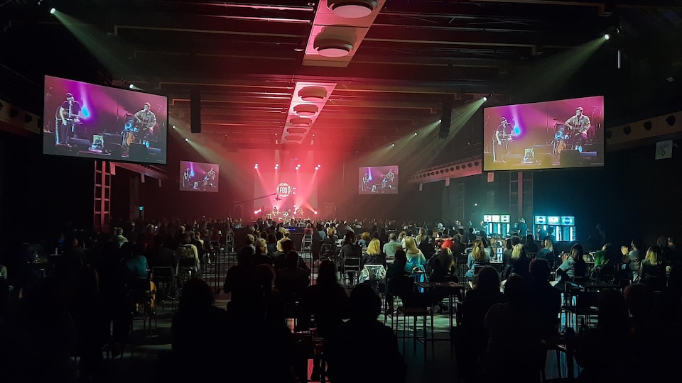 A crowd attends a meeting.