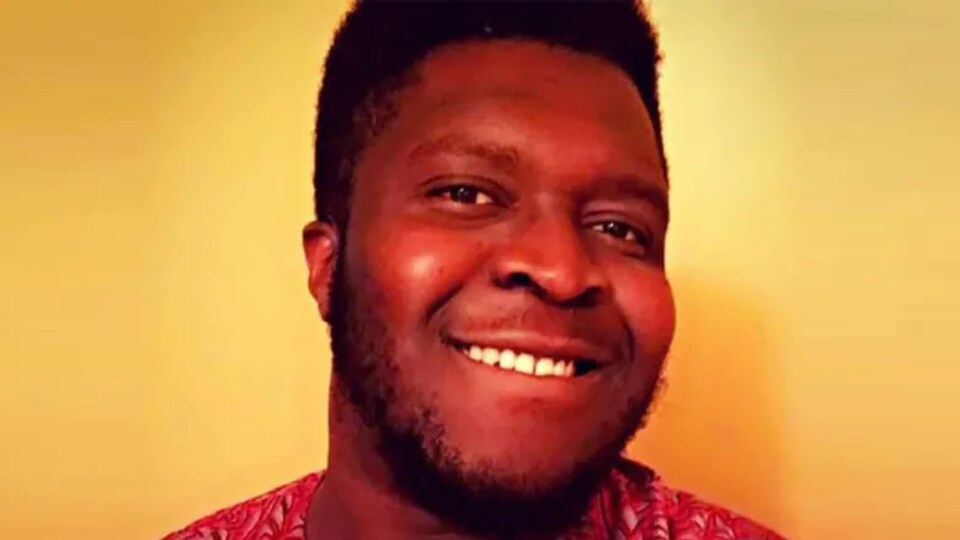 Visage souriant d'un homme.